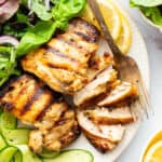 Closeup of Greek yogurt chicken on plate with fork and salad