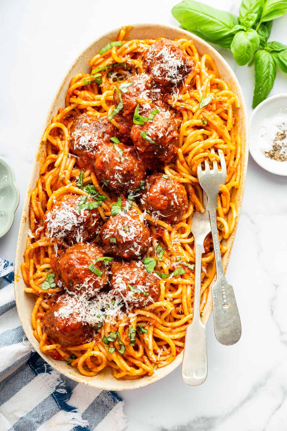 This two-ingredient Instant Pot Spaghetti cooks the pasta in the sauce, and it does it in a pressure cooker so it takes just 20 minutes! Overhead view of Instant Pot spaghetti on platter with meatballs