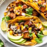 3 air fryer tofu tacos on plate with mango salsa