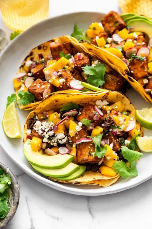 3 air fryer tofu tacos on plate with mango salsa