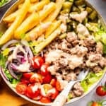 Burger bowl with fries and special sauce.