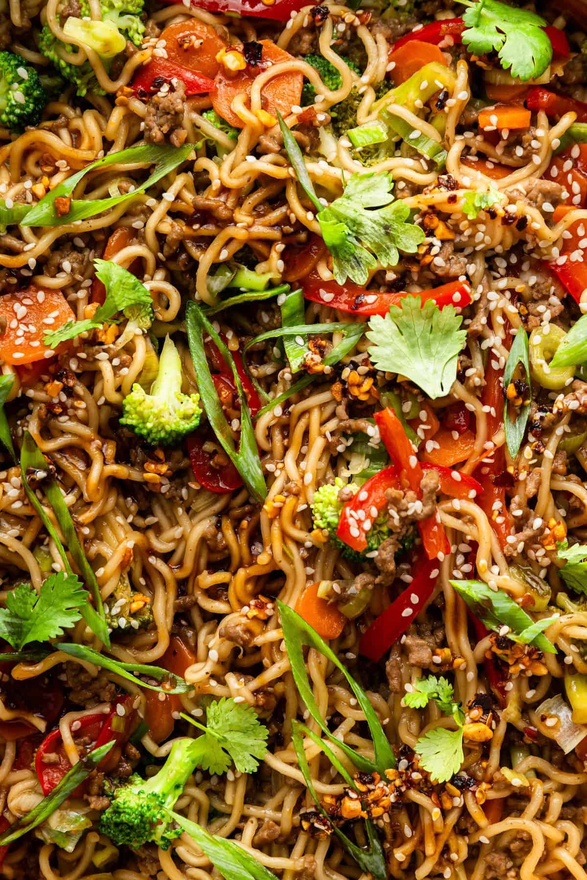 Springy ramen noodles are combined with ground beef and veggies to make this super easy one pan Beef Ramen recipe. Done in 25 minutes! Closeup of beef ramen with vegetables.