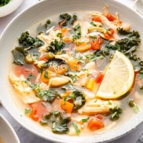 Lemon slice in bowl of chicken vegetable soup.