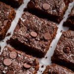 Sliced cottage cheese brownies on parchment paper.