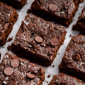 Sliced cottage cheese brownies on parchment paper.