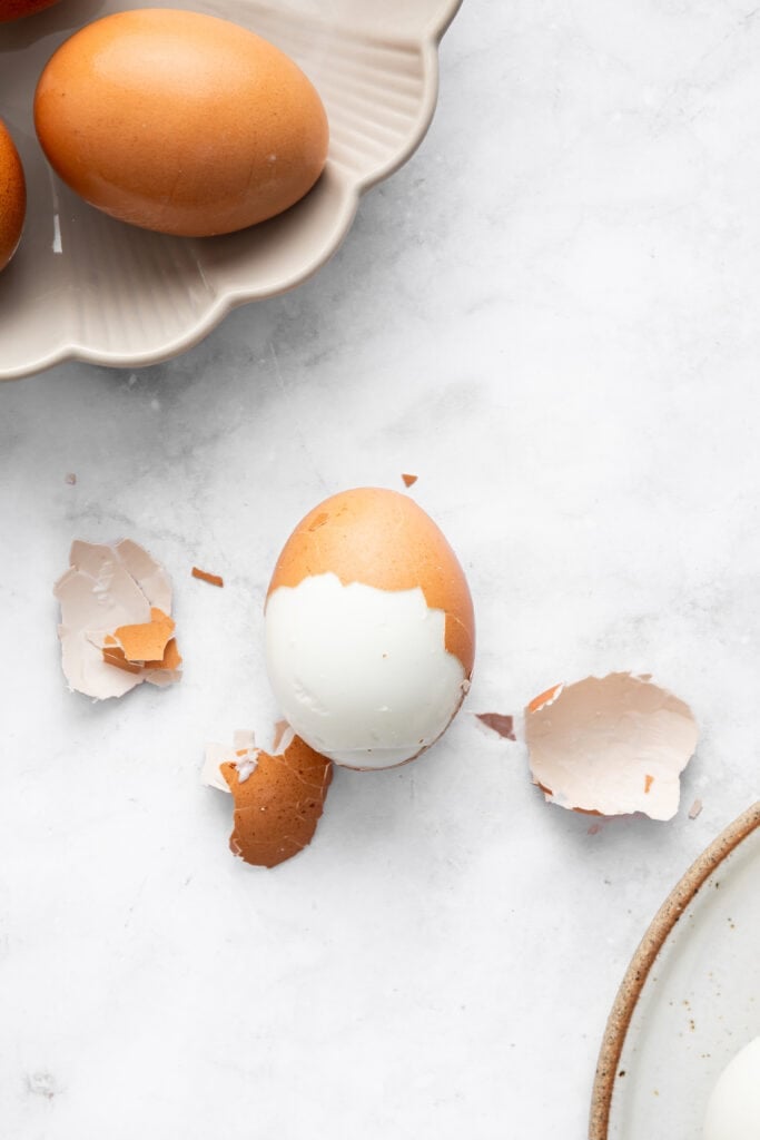Peeling shell from hard-boiled egg.