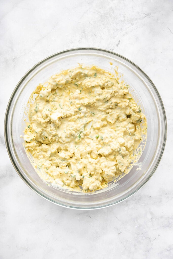 Egg salad in glass mixing bowl.