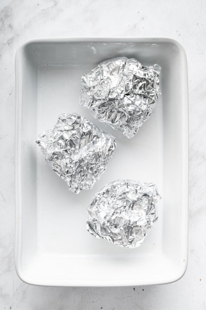 Garlic wrapped in foil for roasting.