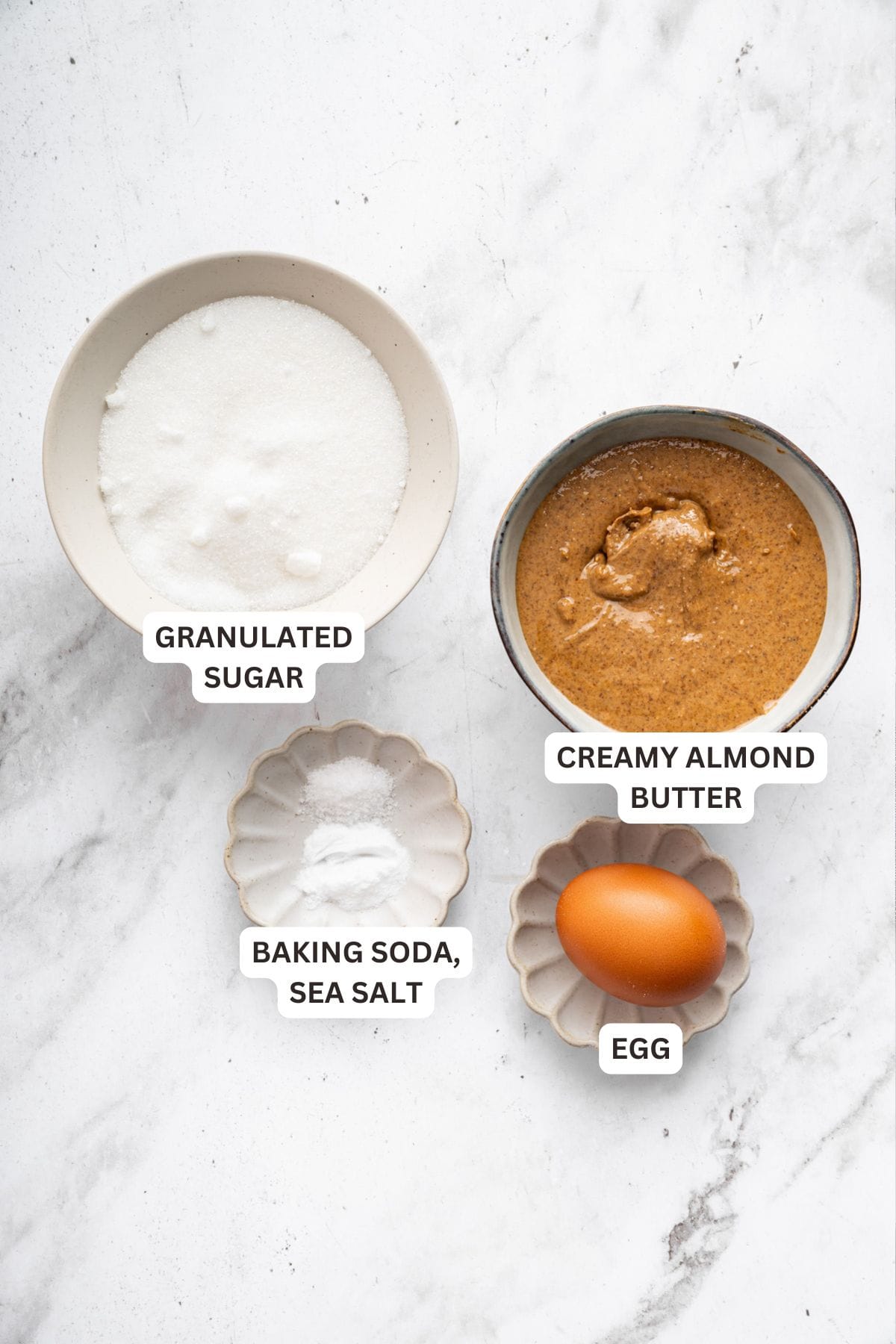 These easy almond butter cookies are made with just 5 ingredients! Naturally gluten-free, chewy with crisp edges, and full of nutty flavor. Ingredients for almond butter cookies with labels.