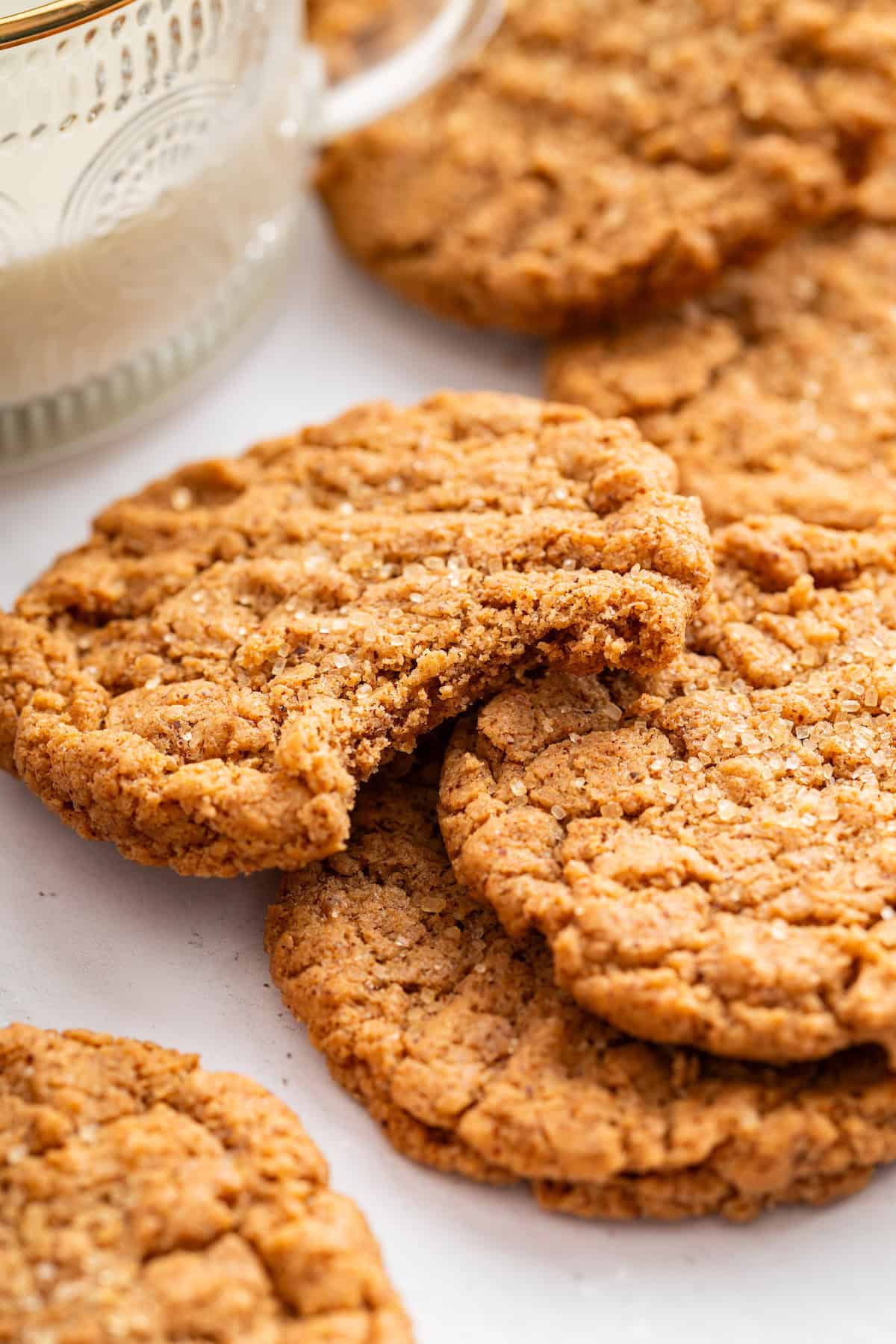 These easy almond butter cookies are made with just 5 ingredients! Naturally gluten-free, chewy with crisp edges, and full of nutty flavor. Pile of almond butter cookies with top cookie bitten into.