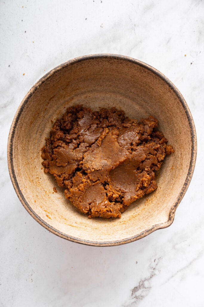 These easy almond butter cookies are made with just 5 ingredients! Naturally gluten-free, chewy with crisp edges, and full of nutty flavor. Almond butter cookie dough in bowl.