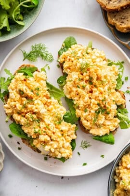 Two slices of toast on plate with cottage cheese egg salad.