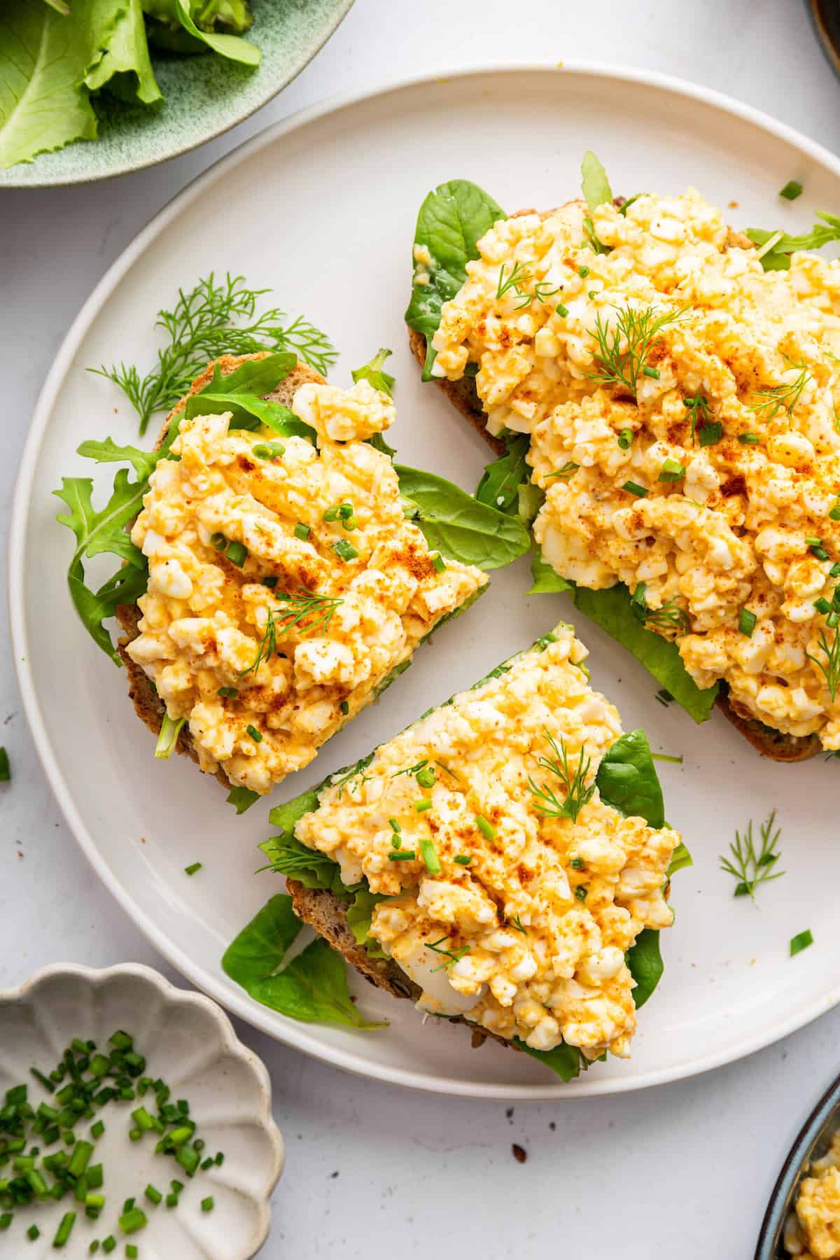 This creamy cottage cheese egg salad is a lighter version of the classic made without mayo. Higher in protein and perfect for meal prep! Cottage cheese egg salad on toast with lettuce.