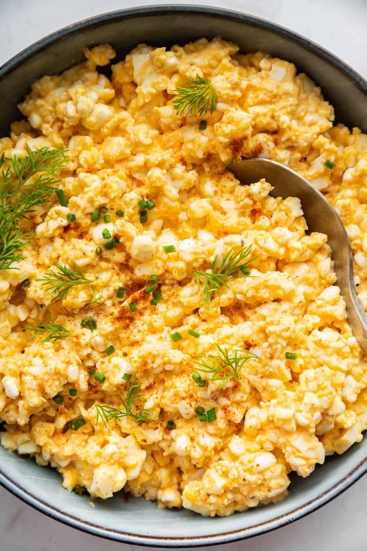 This creamy cottage cheese egg salad is a lighter version of the classic made without mayo. Higher in protein and perfect for meal prep! Egg salad made with cottage cheese in bowl with spoon.