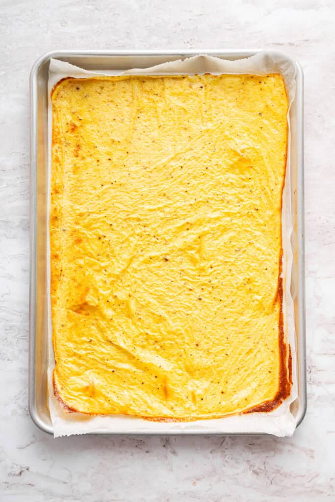 These high protein cottage cheese wraps are made with eggs and pantry seasonings—that’s it. An easy low carb alternative that tastes delish! Cottage cheese wrap in sheet pan.