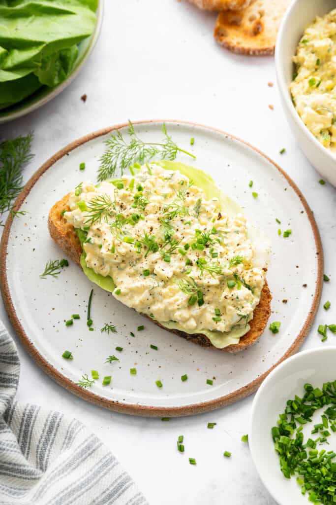 This classic egg salad sandwich on toasty sourdough is tasty and satisfying. It's perfect for an easy lunch that's ready in just 5 minutes! Egg salad layered on top of lettuce and toasted bread.