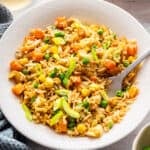 Bowl of vegetable fried rice with fork.