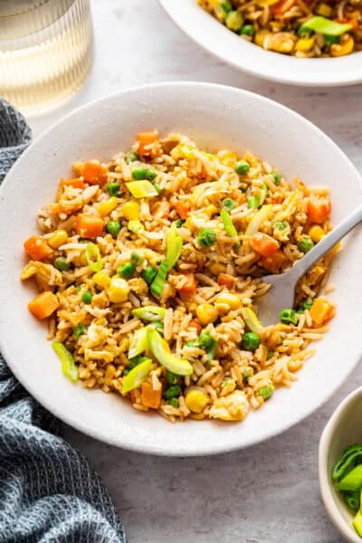 Bowl of vegetable fried rice with fork.