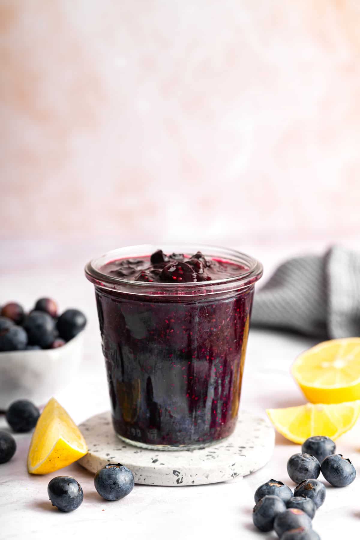 Sweet, jammy berries simmer into a quick blueberry compote that instantly upgrades pancakes, yogurt, desserts, and more. Just 3 ingredients! Jar of blueberry compote with chia seeds.