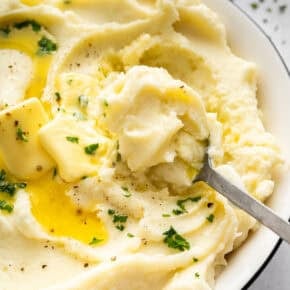 Spoon in bowl of creamy Instant Pot mashed potatoes.