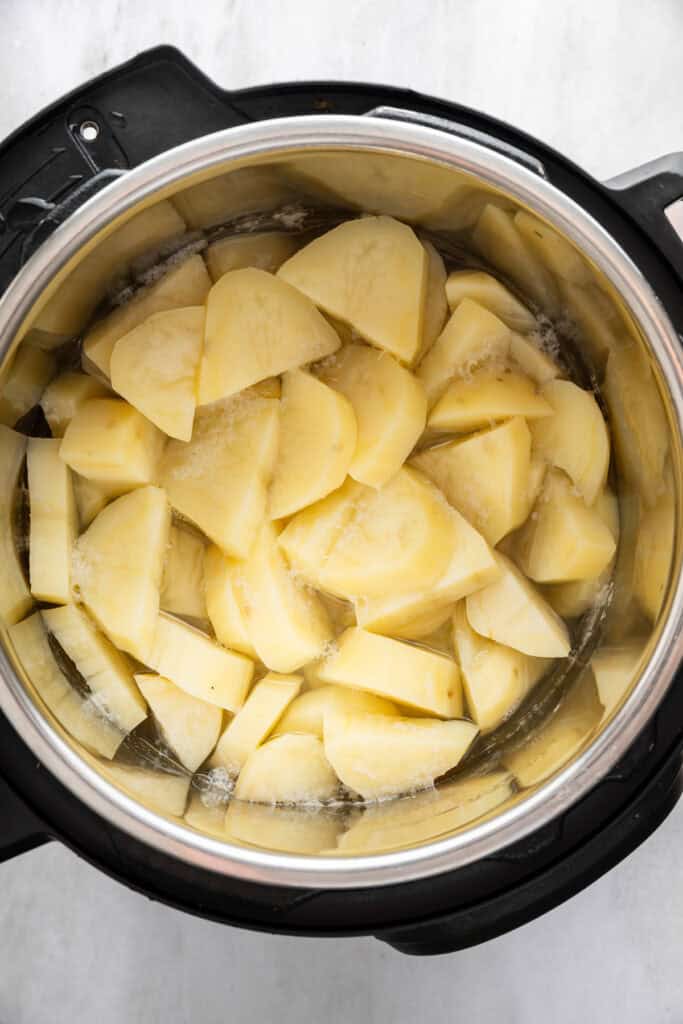 Cooked potatoes and water in Instant Pot.