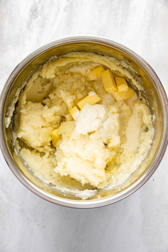 Sour cream and butter added to mashed potatoes in Instant Pot.