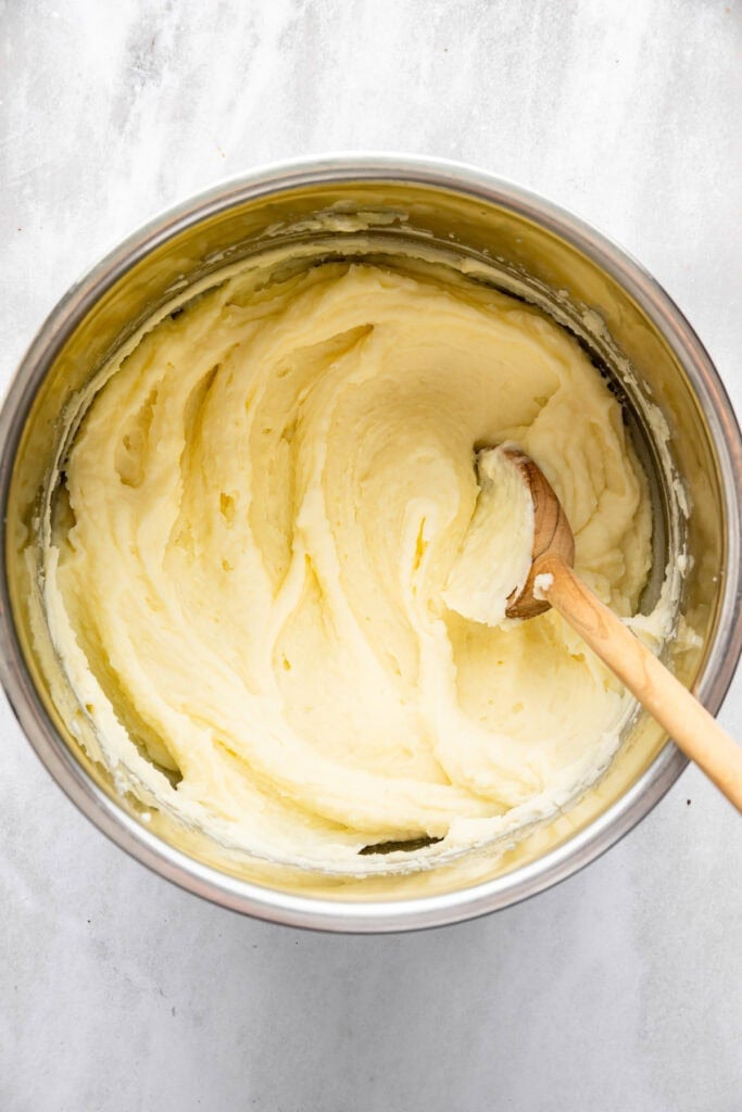 Wooden spoon in Instant Pot with mashed potatoes.