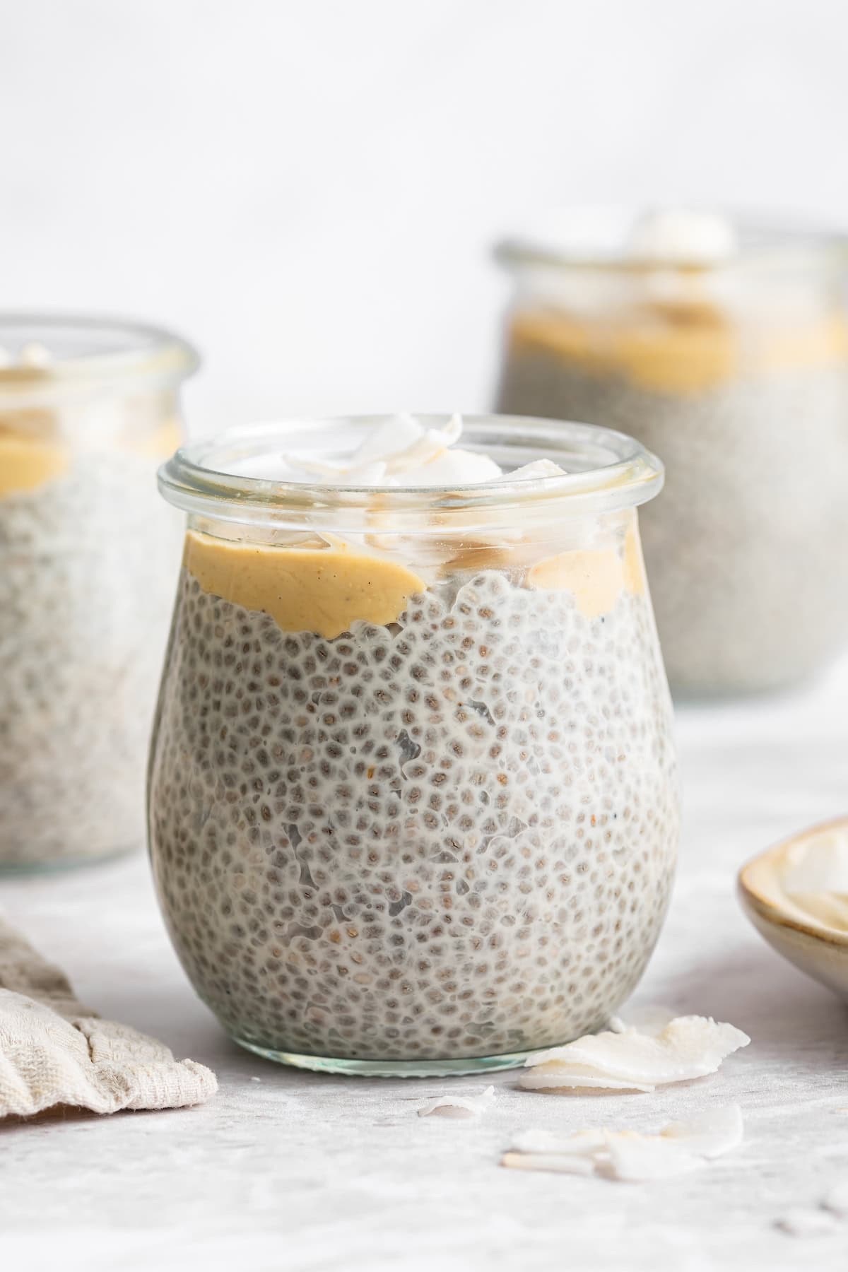 Side view of coconut chia seed pudding in jars.
