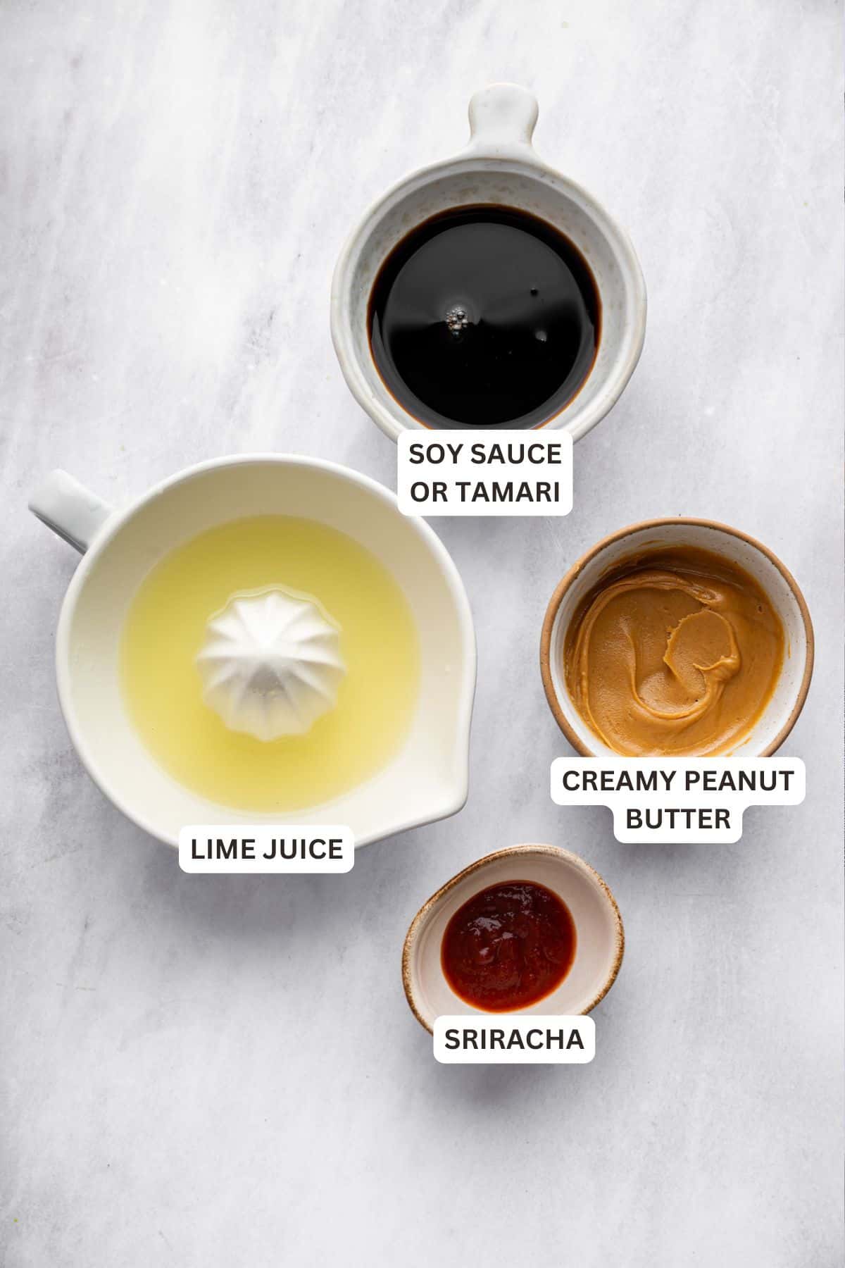 This 4-ingredient peanut sauce recipe yields a smooth, savory, tangy sauce with the perfect spice kick. Ditch the takeout. Make it at home! Labeled ingredients for Thai peanut sauce recipe.