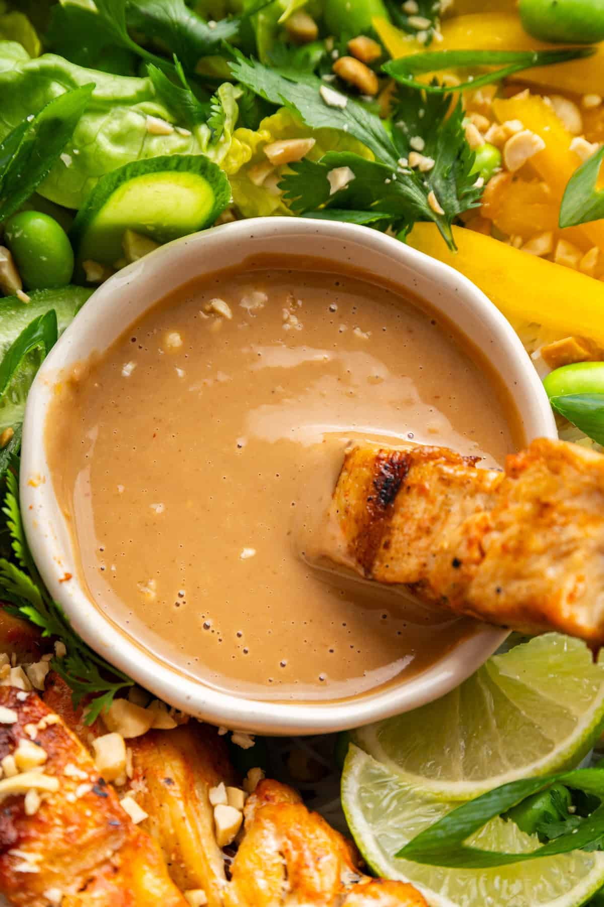 This 4-ingredient peanut sauce recipe yields a smooth, savory, tangy sauce with the perfect spice kick. Ditch the takeout. Make it at home! Dipping tofu sauté into peanut sauce.