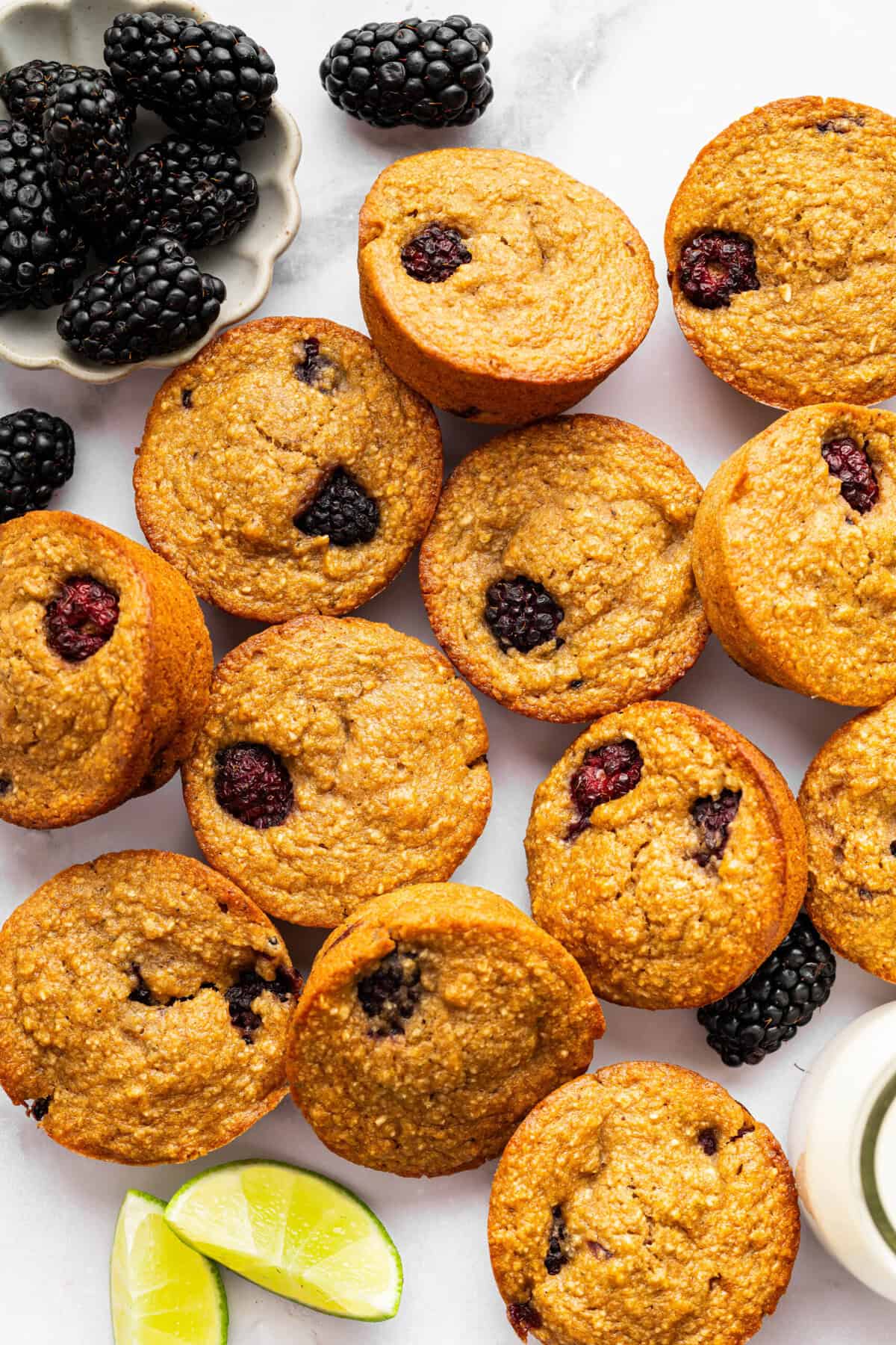 Topped with a smooth coconut-lime glaze, these easy, tender, GF blackberry muffins are a fabulous way to celebrate berry season. Overhead image of blackberry lime muffins.