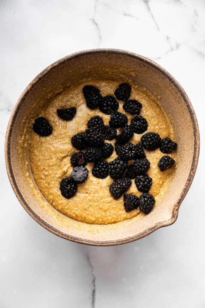 Topped with a smooth coconut-lime glaze, these easy, tender, GF blackberry muffins are a fabulous way to celebrate berry season. Adding blackberries to gluten-free muffin batter.
