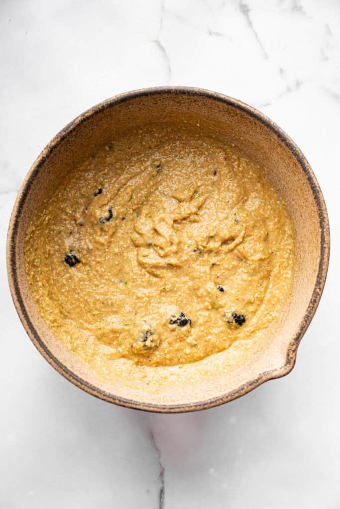 Topped with a smooth coconut-lime glaze, these easy, tender, GF blackberry muffins are a fabulous way to celebrate berry season. Gluten-free blackberry-lime muffin batter in a bowl.