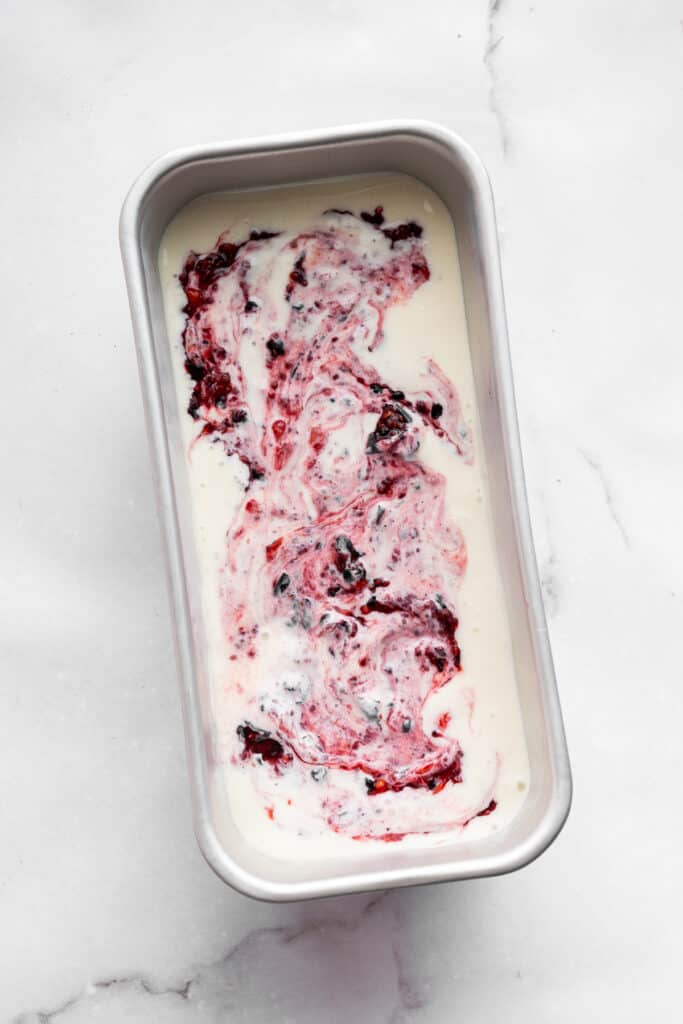 This Greek yogurt ice cream is smooth, creamy, packed with protein, and lightly sweetened with honey and a colorful swirl of fresh berries. Swirling a berry-chia seed mixture into a Greek yogurt ice cream base.