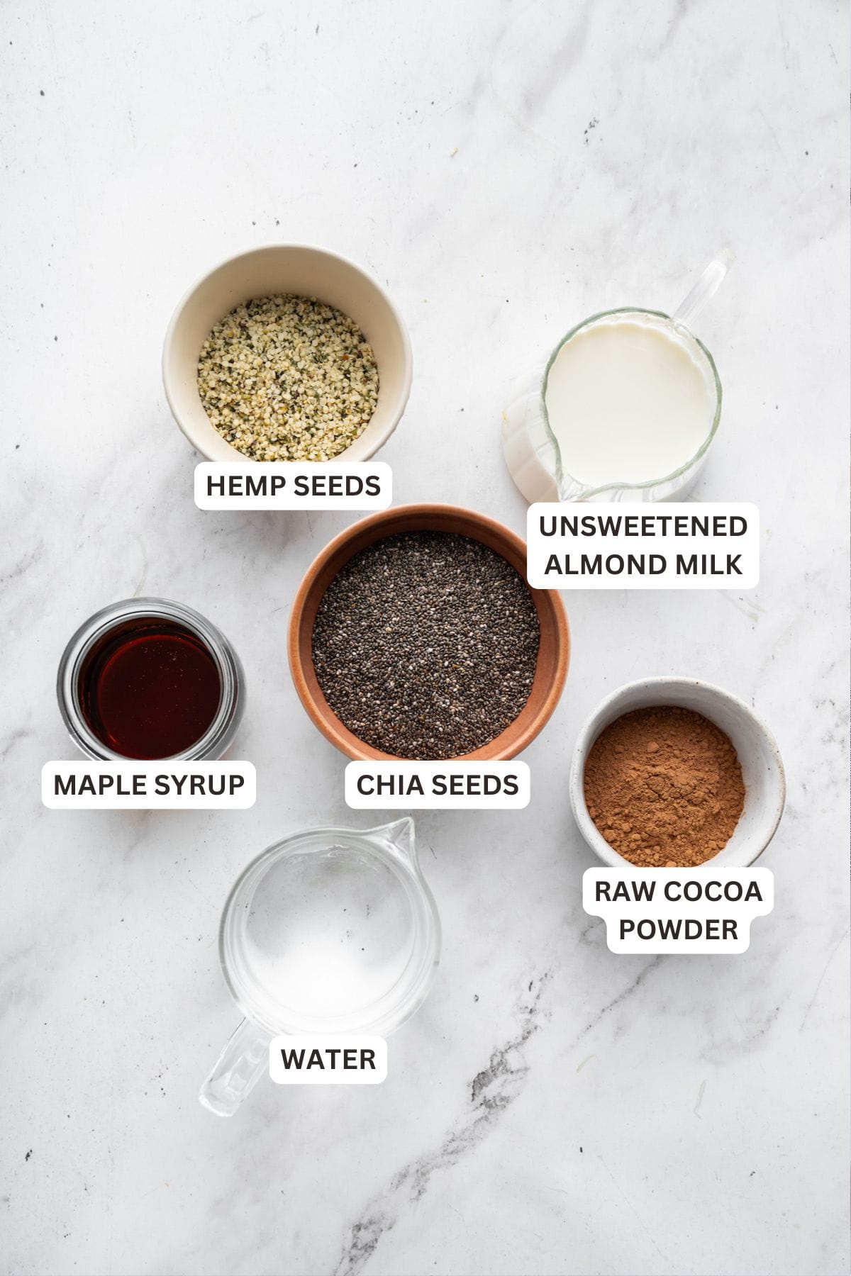 This creamy 5-ingredient chocolate chia pudding packs a powerful punch of protein and just-sweet-enough chocolate pizzaz. And it's so easy! Labeled ingredients for chocolate chia seek pudding.