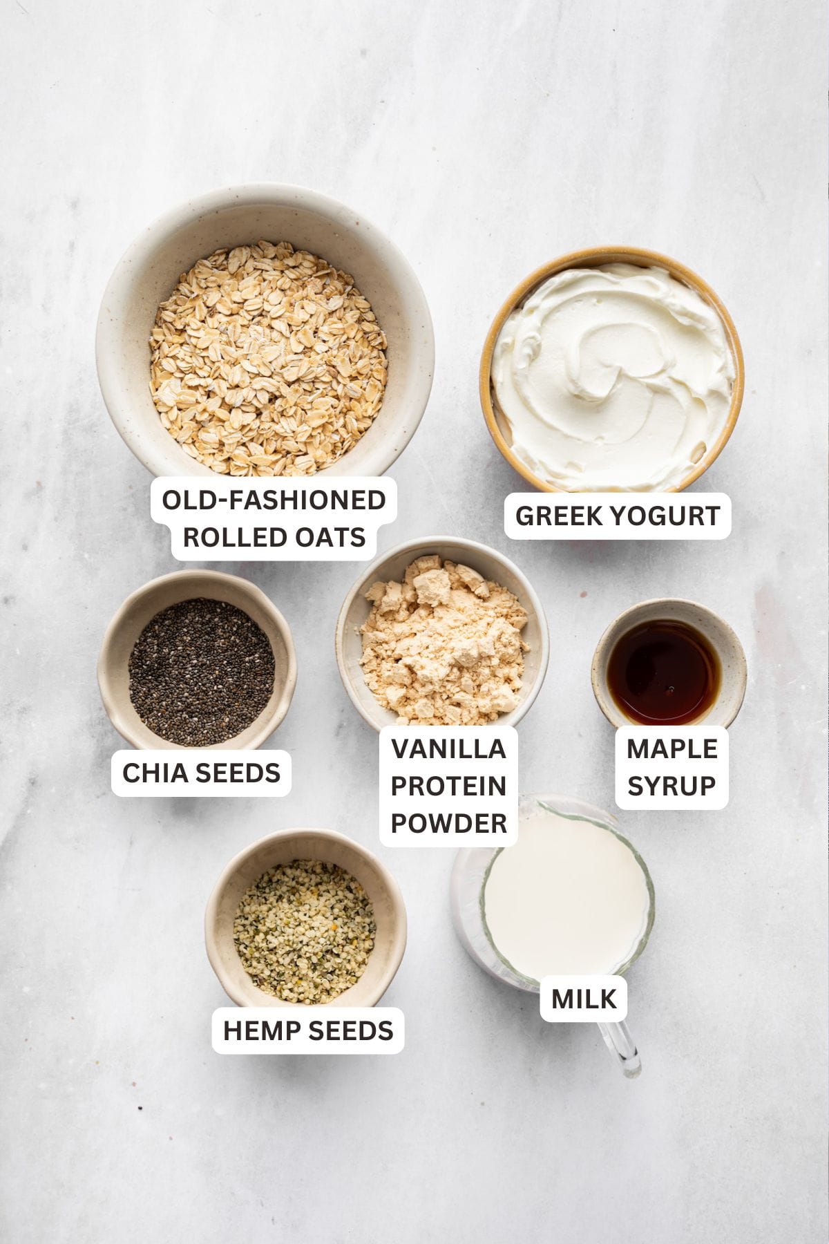 These high-protein overnight oats are so thick and creamy with a little tang from Greek yogurt and a hit of sweetness from maple syrup. Labeled ingredients for high protein overnight oats.