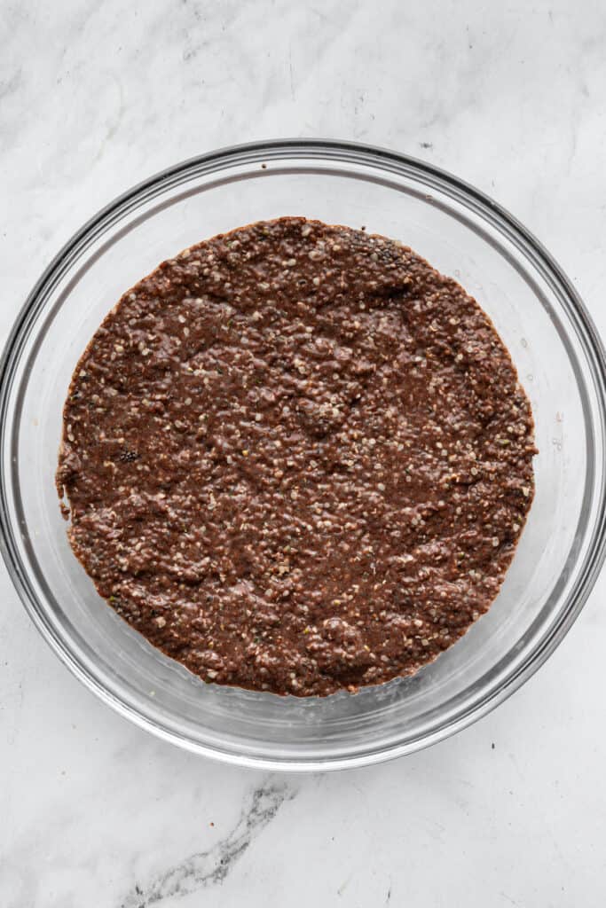 This creamy 5-ingredient chocolate chia pudding packs a powerful punch of protein and just-sweet-enough chocolate pizzaz. And it's so easy! Chilled, thickened chocolate chia seed pudding in a bowl.