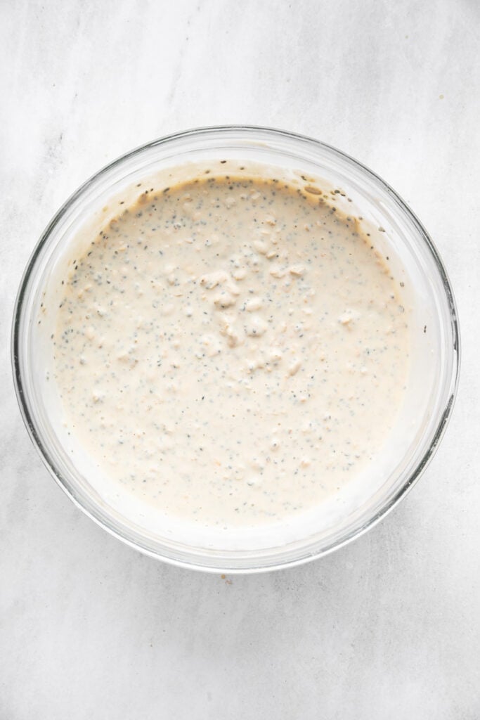These high-protein overnight oats are so thick and creamy with a little tang from Greek yogurt and a hit of sweetness from maple syrup. Oats, seeds, Greek yogurt, milk, maple syrup, and protein powder mixed together in a jar.